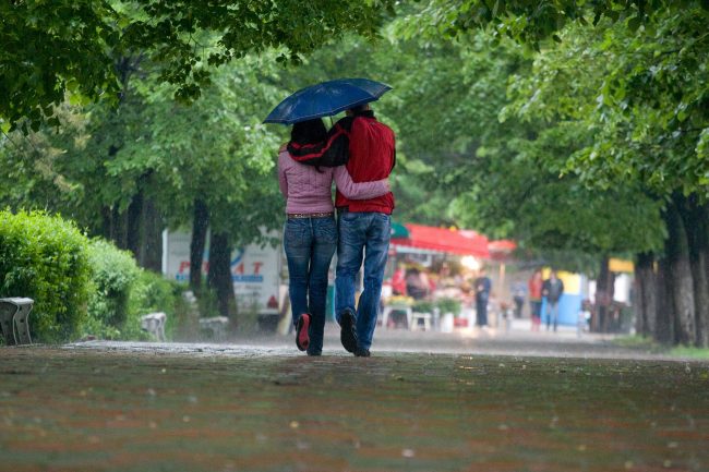 A young couple is walking in the park during a torrential rain in Galați, Romania on May 4th, 2008.