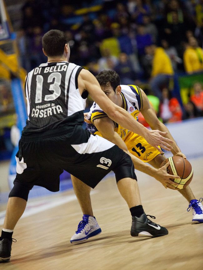Two basketball players are fighting for the ball in a match between Pepsi Caserta (IT) and Sutor Montegranaro (IT) in Porto San Giorgio, Italy on December 18th, 2010.