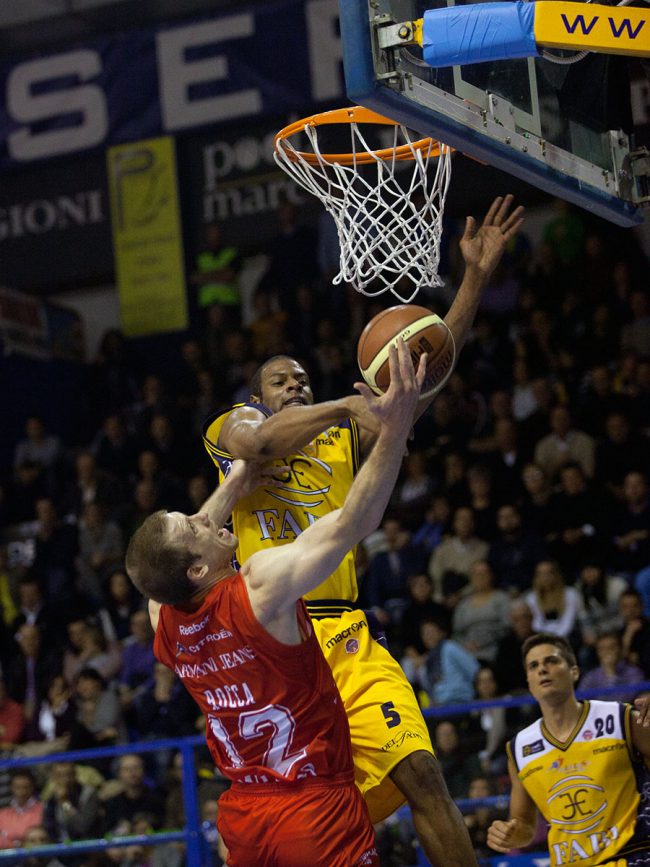Two basketball players are fighting for the ball in a match between Armani Jeans Milano (IT) and Sutor Montegranaro (IT) in Porto San Giorgio, Italy on November 28th, 2010.