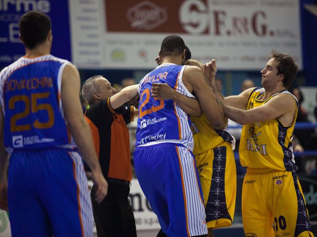 Two basketball players are having a fight during a match between ENEL Brindisi (IT) and Sutor Montegranaro (IT) in Porto San Giorgio, Italy on March 27th, 2011