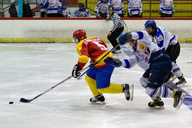 Hockey players are fighting for the puck in a game played in Galați, Romania on January 10th, 2008.