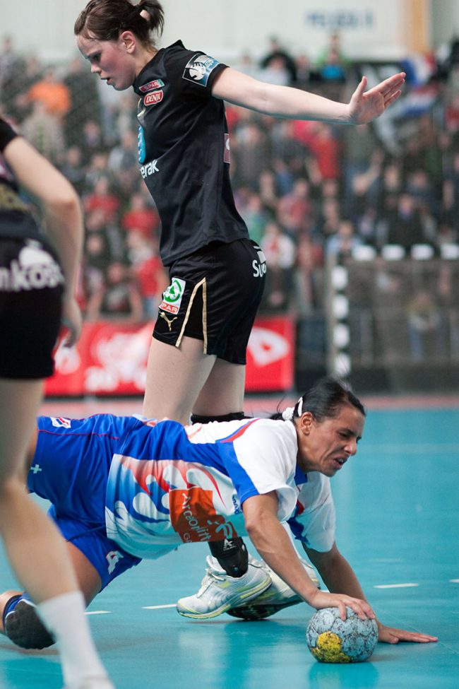 Handball players are fighting for the ball in a game played in Galati, Romania on the March 21th, 2009.