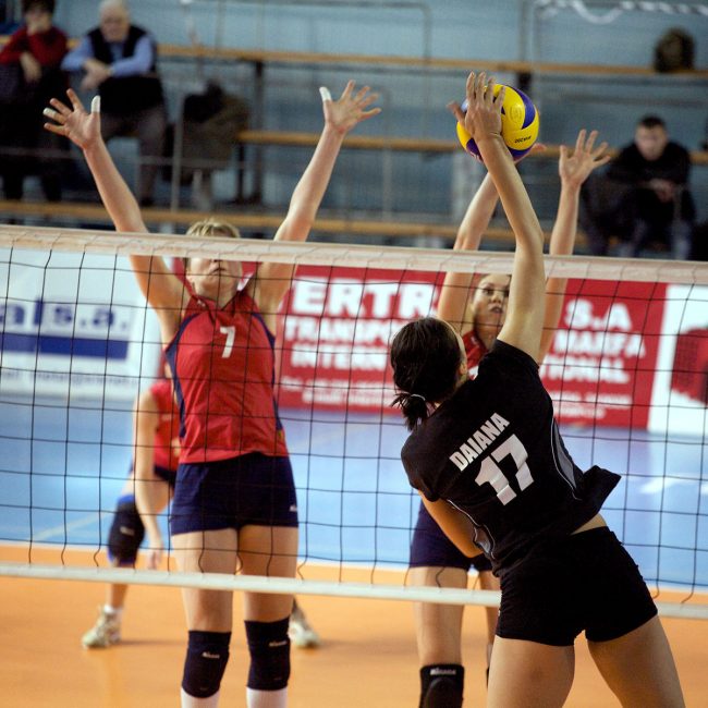 Voleyball players are fighting over the ball in a game played in Galați, Romania on April 24th, 2010.