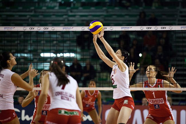 Volley players are playing in a CEV Cup match between Scavolini Pesaro (IT) and Dinamo București (RO) in Pesaro, Italy on December 8th, 2010.
